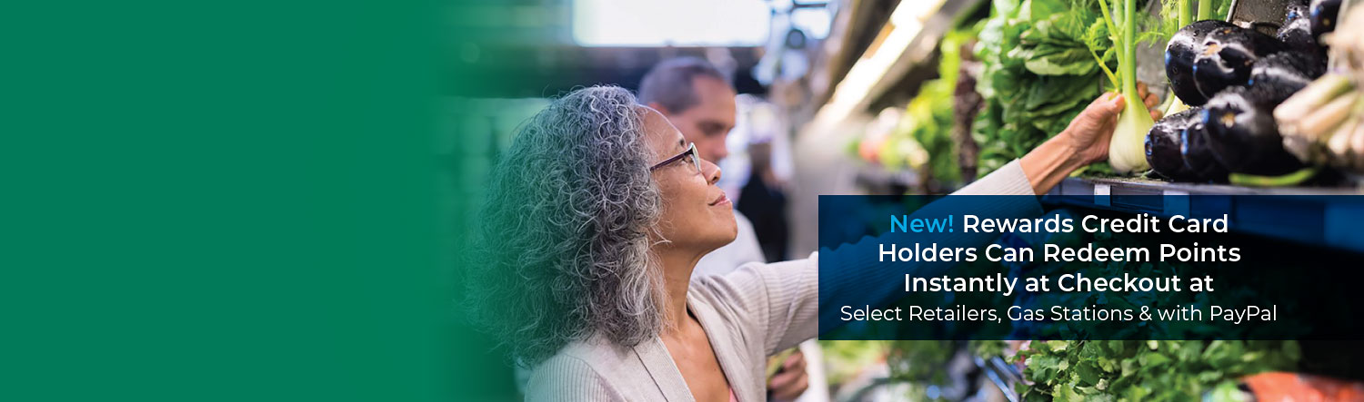 Woman reaching for produce in a grocery store. Text reads New! Rewards Credit Card holders can redeem points instantly at checkout at select retailers, gas stations, and with PayPal.