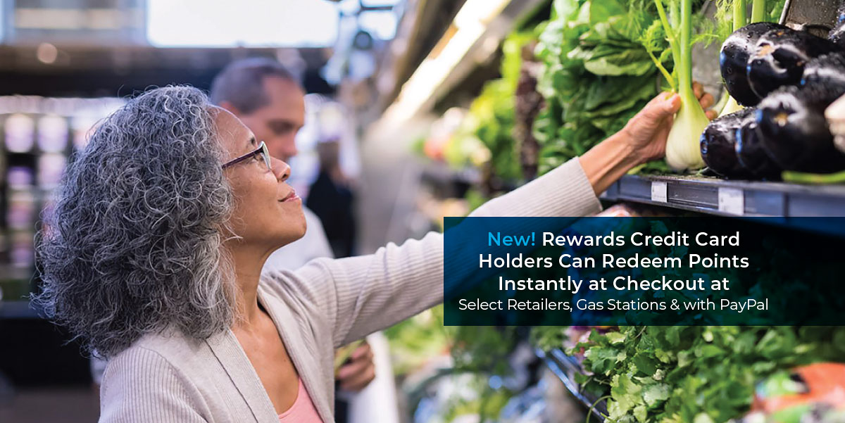 Woman reaching for produce in a grocery store. Text reads New! Rewards Credit Card holders can redeem points instantly at checkout at select retailers, gas stations, and with PayPal.